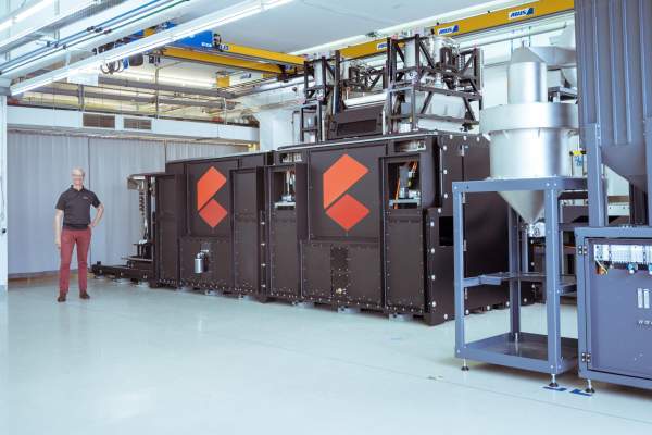 Intermediate state of the prototype of the AMCM M 8K with person to the left of it