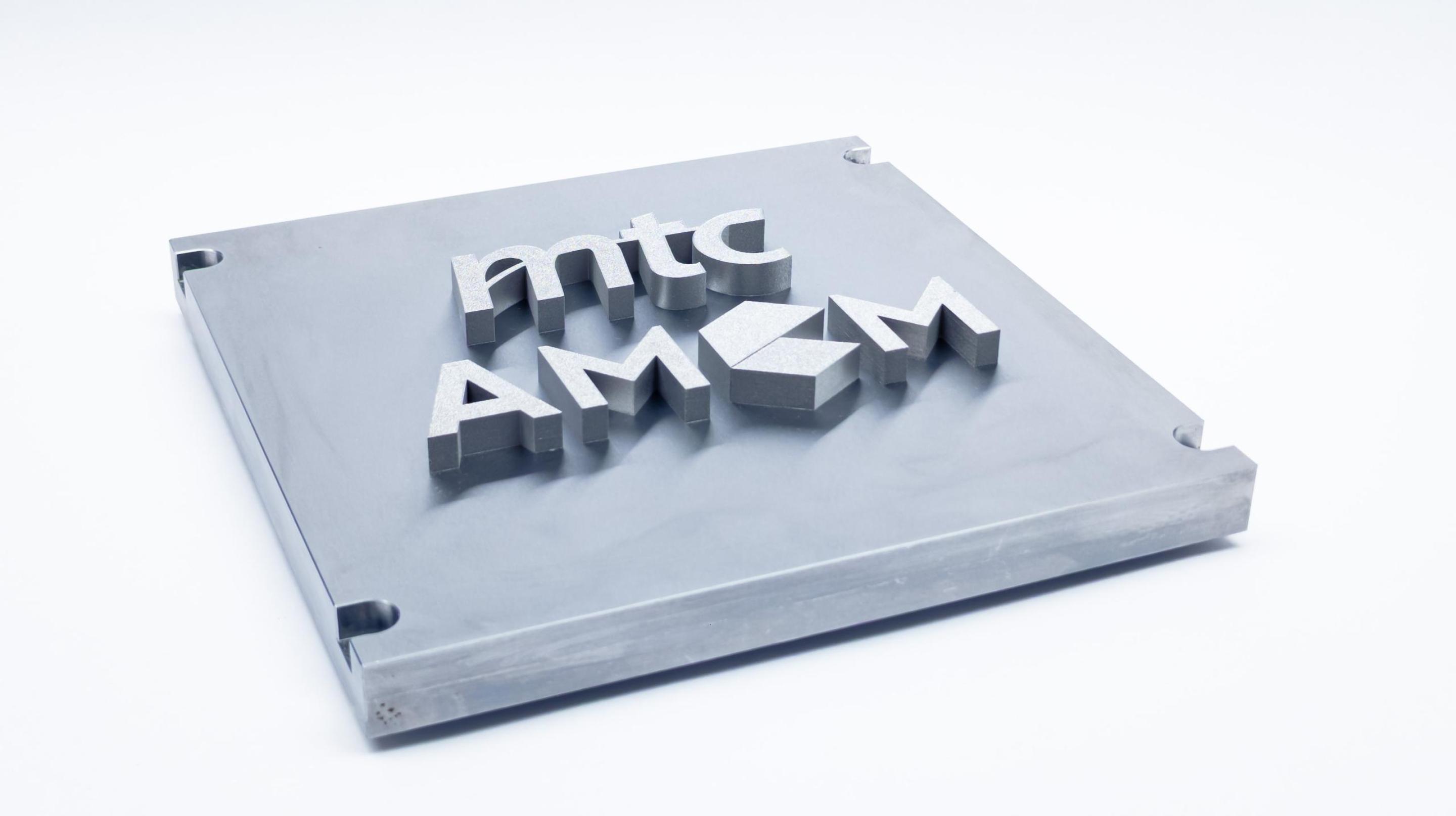 Section of a component manufactured using beam forming technology, the mtc and AMCM logos are printed in relief