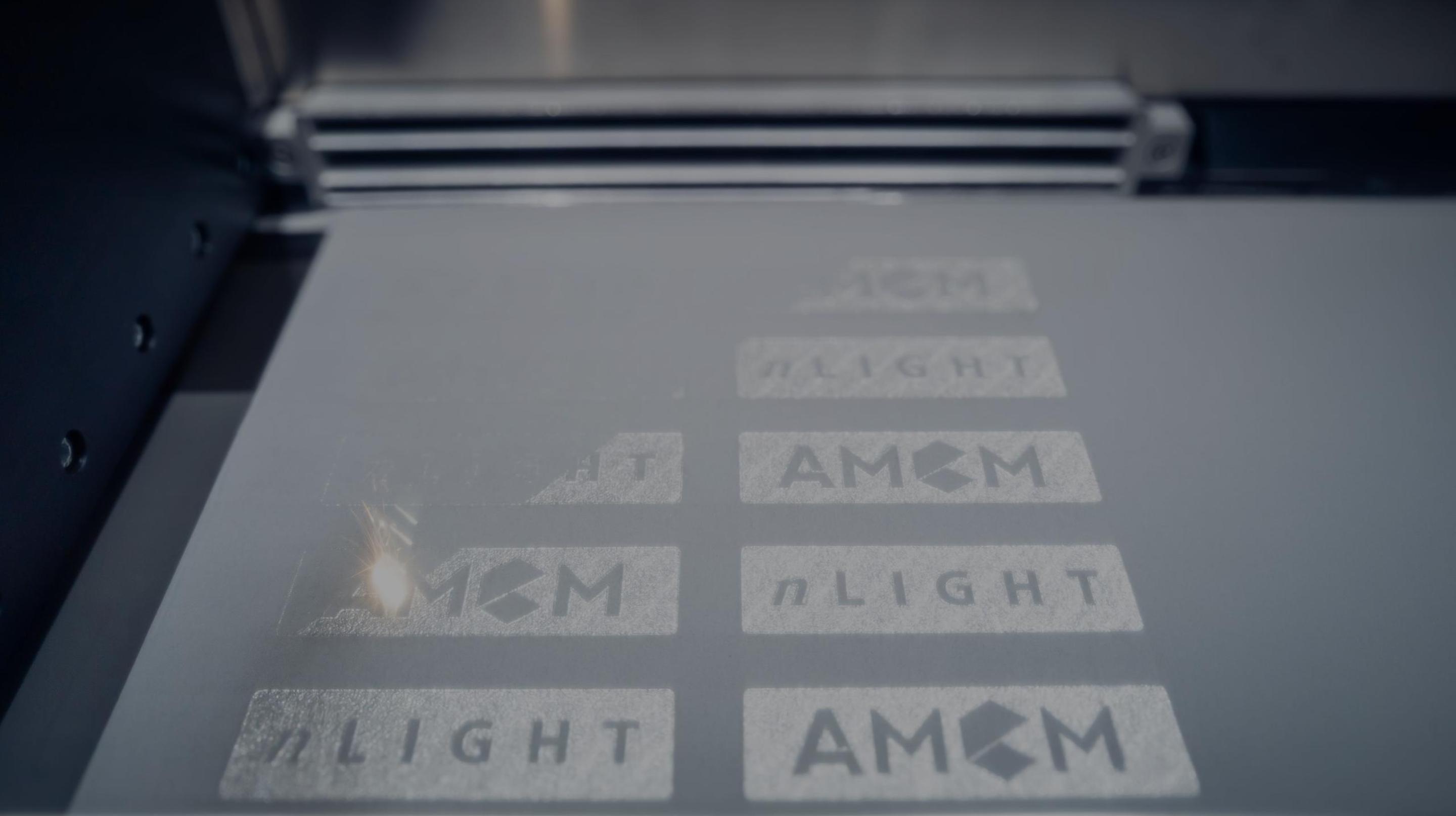 Powder Bed Fusion with Laser Prints AMCM and nLIGHT Logos