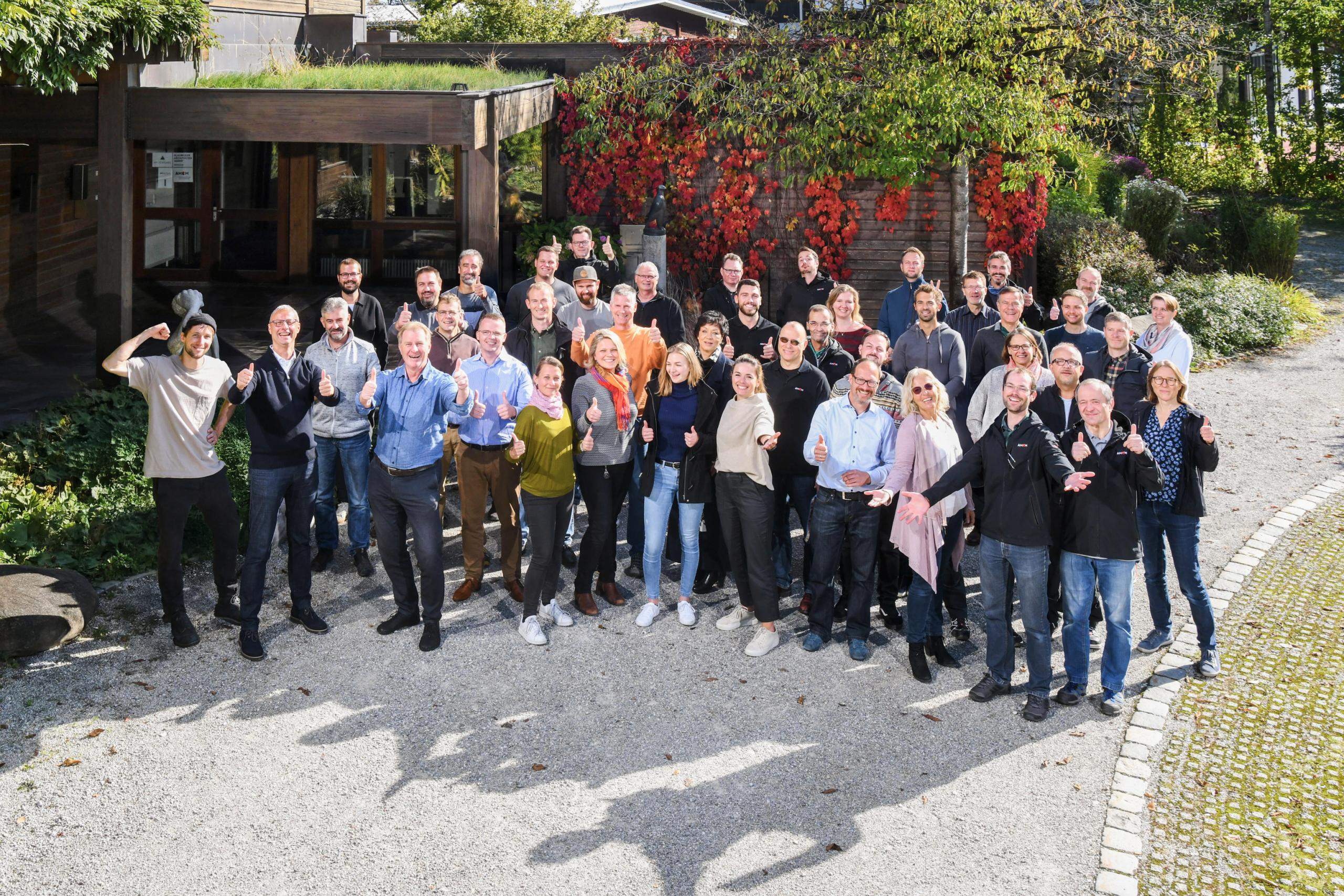 Happy AMCM Employees in Front of Company Building