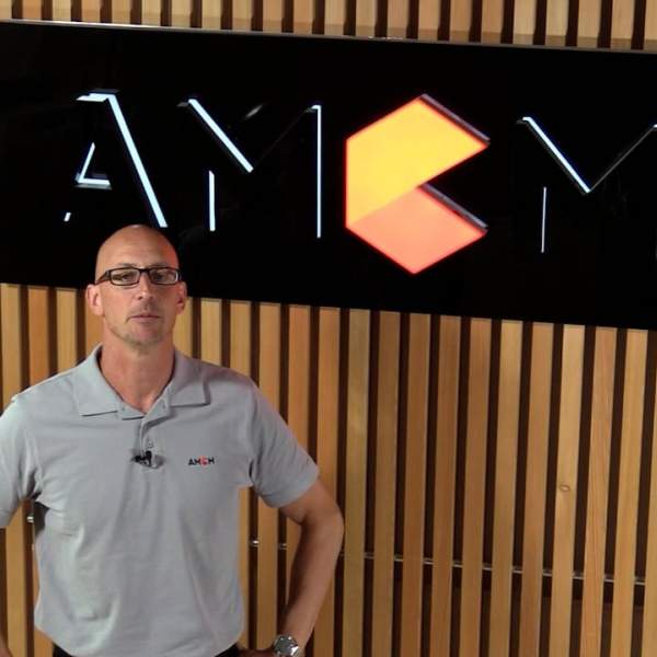 AMCM employee with AMCM logo